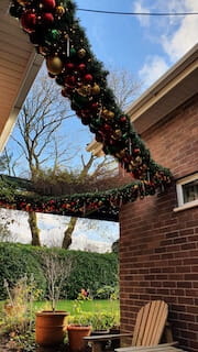 This external be-icicled garland with its abundant rich reds, soft golds and forest greens was a suspended, and very happy surprise for our client’s lovely wife. 